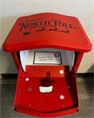 red mailbox that has an arrow pointing to where letters go