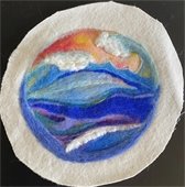 a piece of needle felt art that has blue, purple and orange felting 