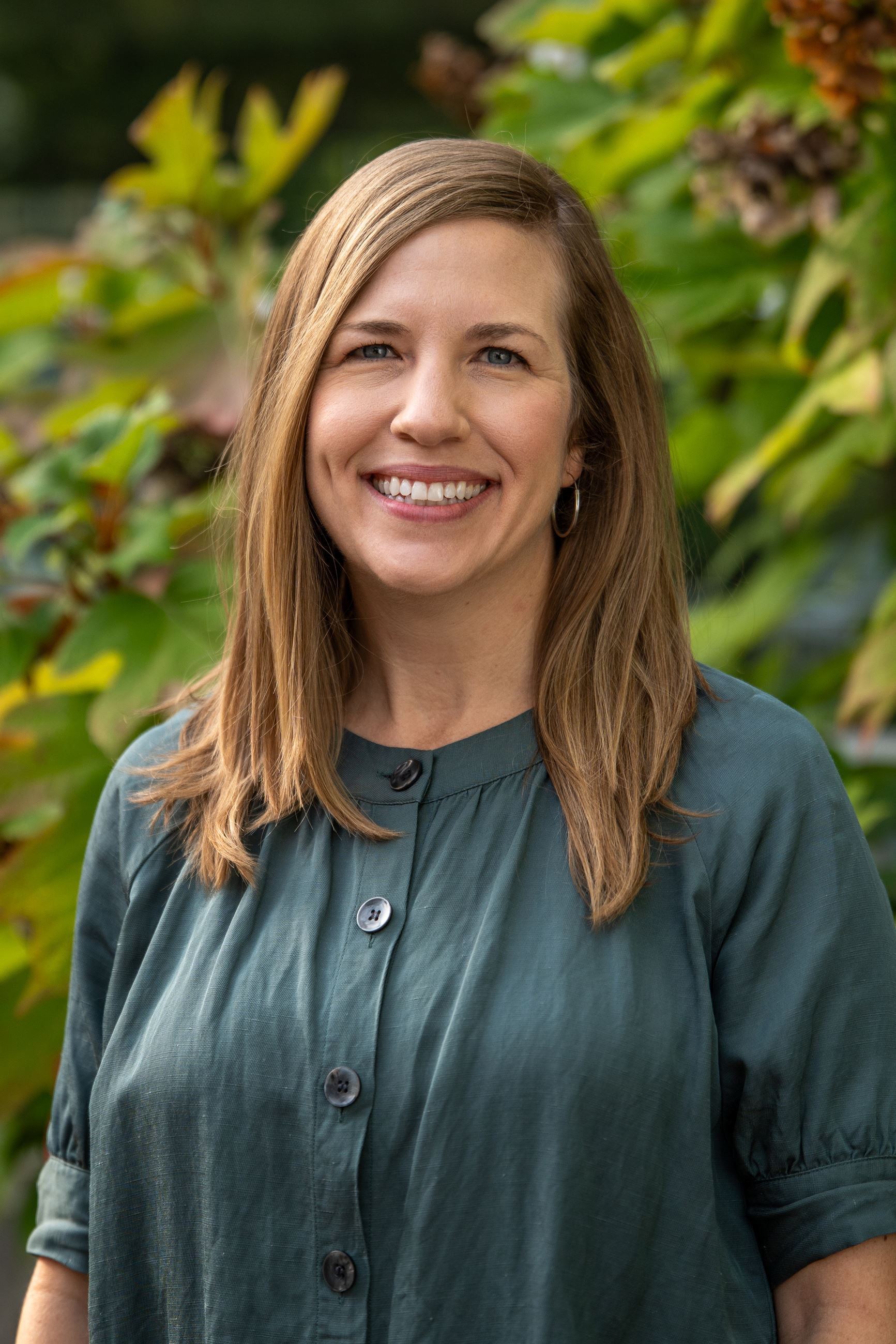 woman with green shirt and blonde hair