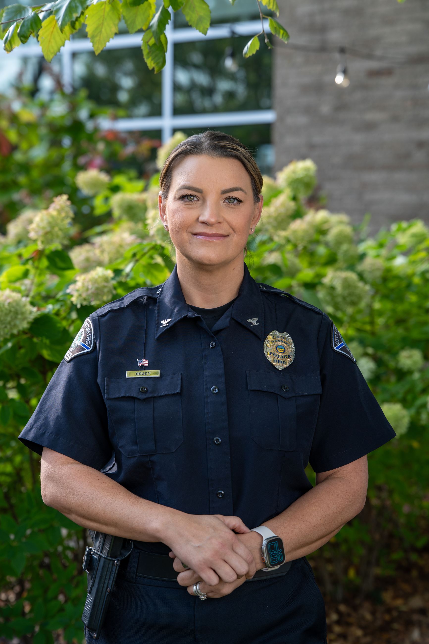 woman holding her hands with a police uniform on
