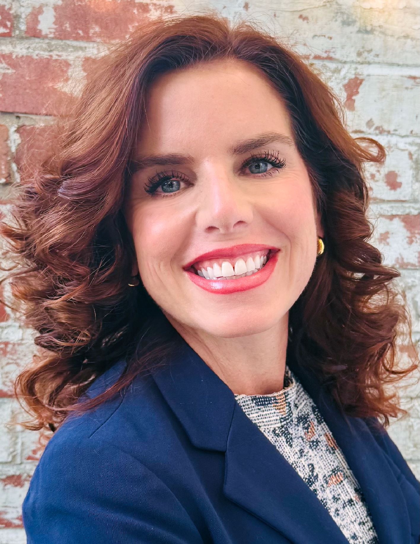 red haired woman smiling at the camera